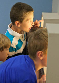 children look at Panoply animations in a museum